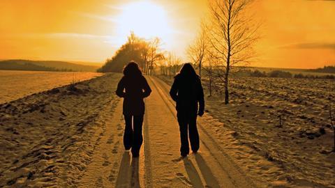 women walking on path