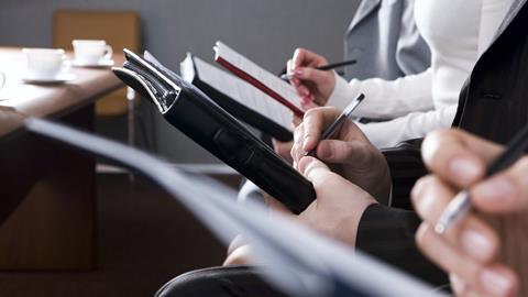 Journalists taking notes in court