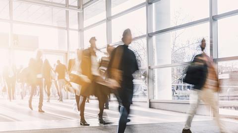 Blurred office workers walking into building