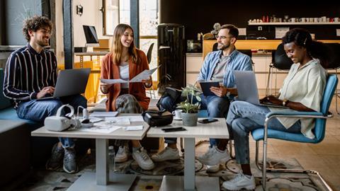A group of young colleagues chat in the office