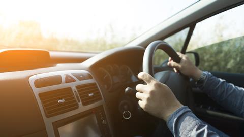 An anonymous man driving a car