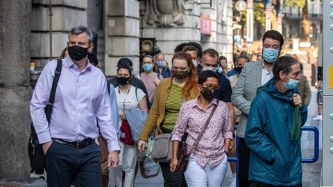 Masked London commuters make their way to work during the coronavirus