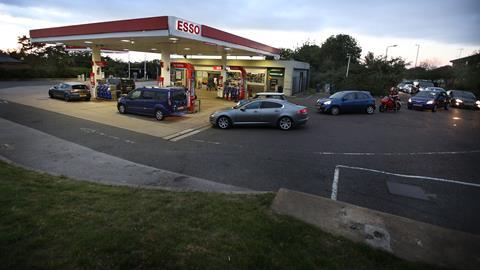 Customers queue for Fuel at an Esso petrol station, near Peterborough