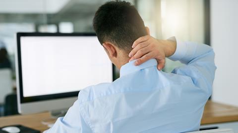 Man sat at desk/computer with neck pain
