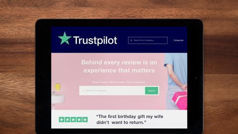 A tablet screen shows the Trustpilot homepage 
