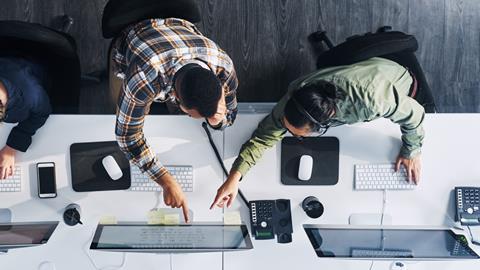 Two colleagues work together in the office