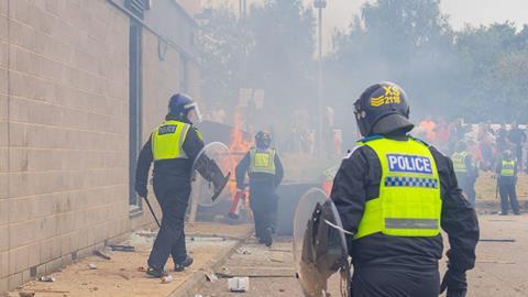 Police respond as rioters start a fire in Rotherham