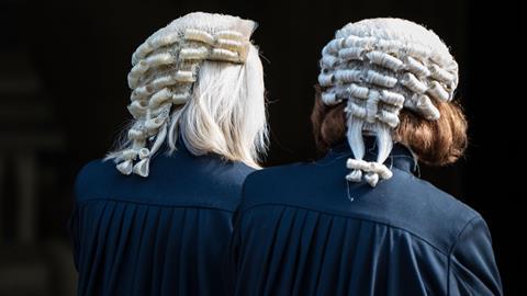 Two barristers wearing wigs and robes