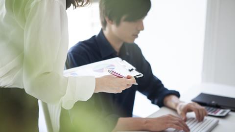 A young male office worker and his colleague