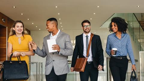 Colleagues walk through the office together