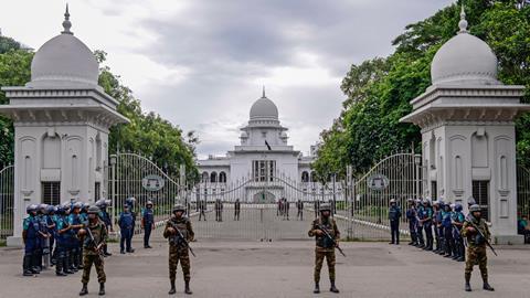 Police stand guard after Bangladesh’s top court scaled back a controversial quota system for government job applicants