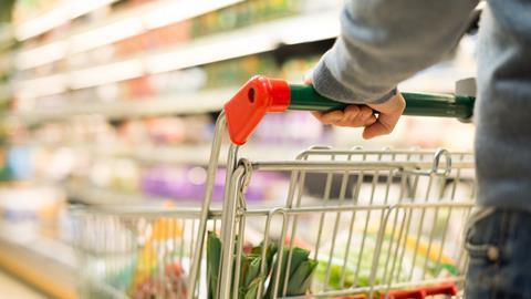 A man pushes a trolley in a supermarket