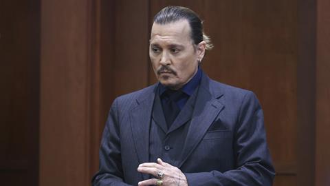 Actor Johnny Depp stands in the courtroom at the Fairfax County Circuit Court