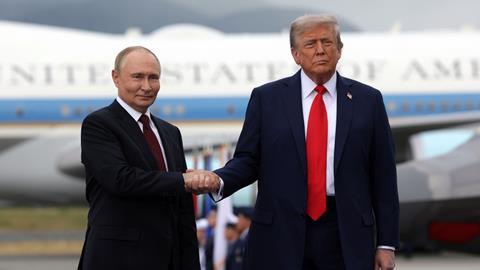 Russian President Vladimir Putin and US President Donald Trump shake hands in Alaska