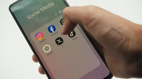 Social media app icons displayed on a phone