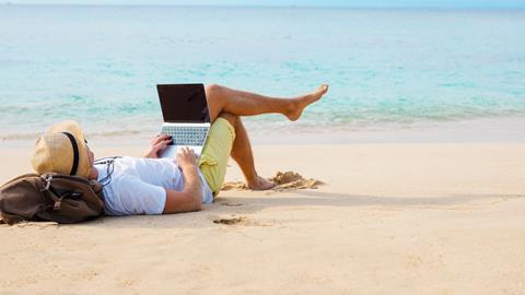 Man checking emails on the beach