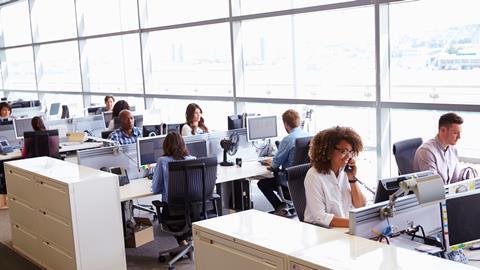 Colleagues working at their desks in an open-plan office