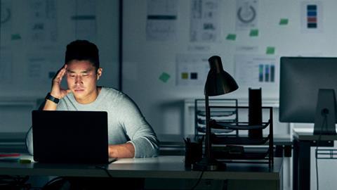 A man works on a laptop in the office