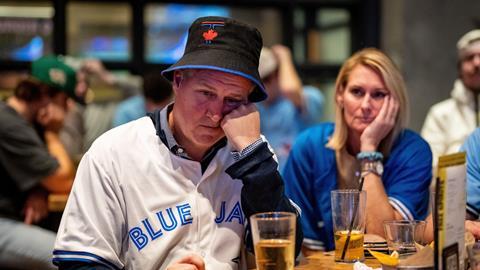 A Toronto Blue Jays fan reacts in a bar after the LA Dodgers defeated the Blue Jays in Game 7 of baseball's World Series. Vancouver, British Columbia, 1 November 2025