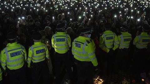 People attend a vigil for Sarah Everard by a band stand in Clapham Common, London