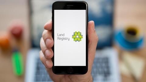 The Land Registry logo is displayed on a phone