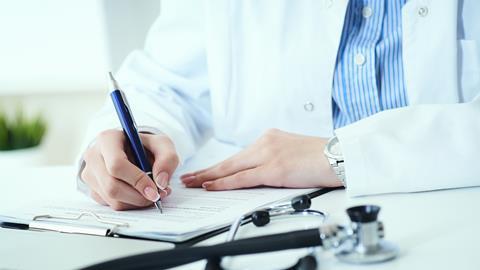 A doctor writing up a patient's medical records
