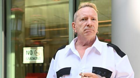 Sex Pistols frontman John Lydon, also known as 'Johnny Rotten' poses for photographs outside the Rolls building in London