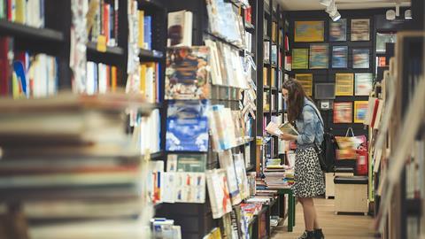 A young woman browses the shelves in a bookshop
