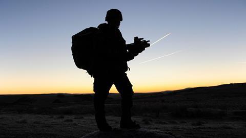 The silhouette of a British soldier on patrol