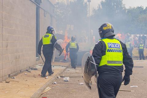 Police respond as rioters start a fire in Rotherham