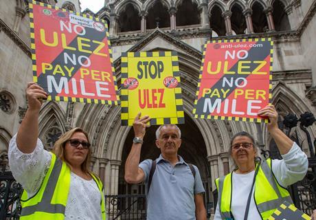 Activists stage a protest outside the Royal Courts of Justice as the High Court decides in favor of London mayor Sadiq Khan in a lawsuit against the Ultra Low Emission Zone expansion