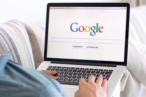 Man uses Google on laptop