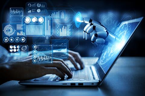 A robot's hand emerges from a laptop screen