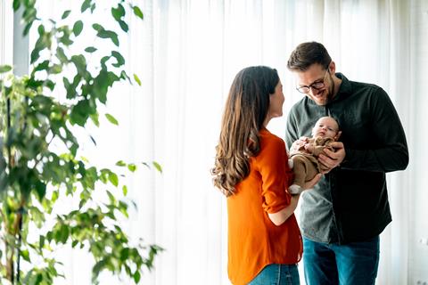 Couple cradle their newborn