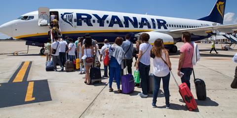 Ryanair passengers queue to board the plane