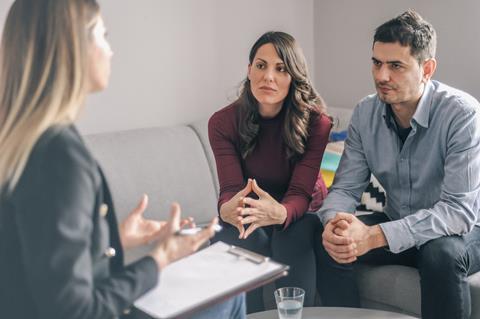 A couple speak to a mediator