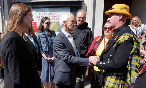 Sir Brian Langstaff (left), chairman of the infected blood inquiry, with victims and campaigners outside Central Hall in Westminster, London, after the publication of the Inquiry report