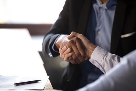 Businessmen shaking hands after signing contract