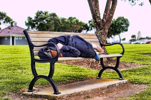 Woman sleeping on bench