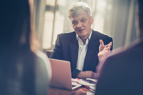 A lawyer speaks to his clients