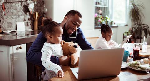 A father juggles childcare with home working