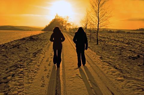 women walking on path