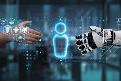 Human hand reaches out to shake robot hand