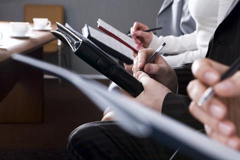 Journalists taking notes in court