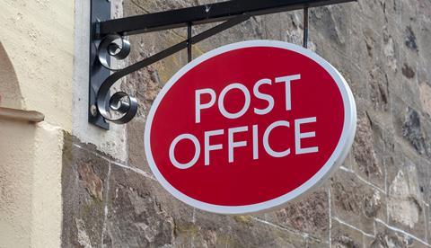 Post office sign hanging outside shop