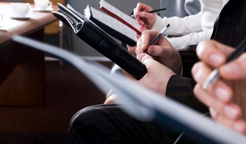 Journalists taking notes in court