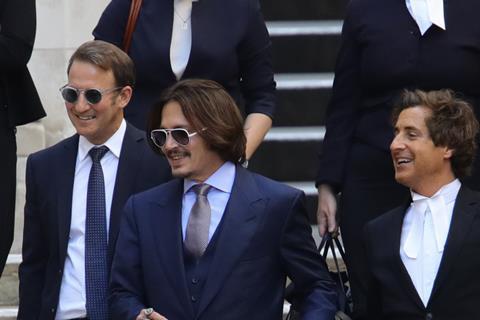 Johnny Depp leaving court with his barristers following libel case