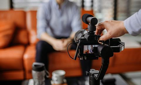 Anonymous man talking into camera