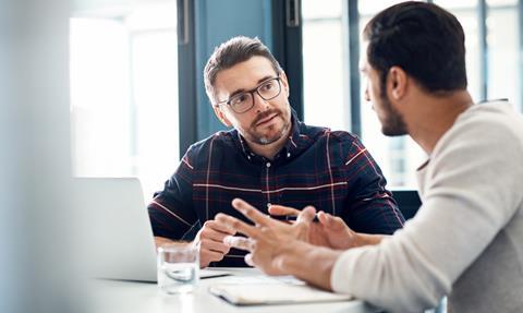 Two coworkers chat