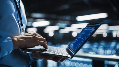 Office worker typing on laptop